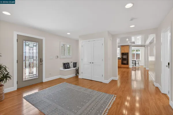 a hallway with kitchen island a sink a stove and refrigerator