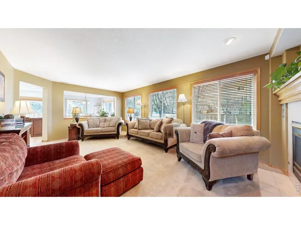 a living room with furniture and large windows
