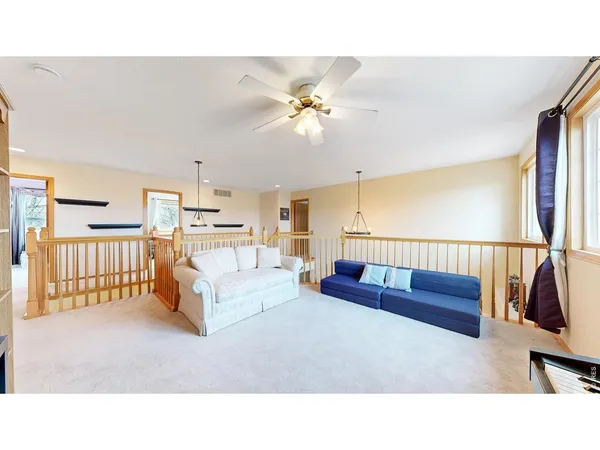 a living room with furniture ceiling fan and a rug