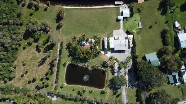 an aerial view of a house with a yard