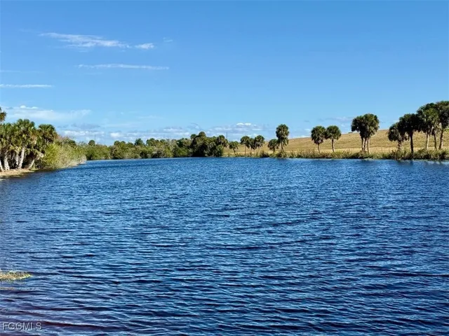 a view of a deck with barbeque grill and a yard