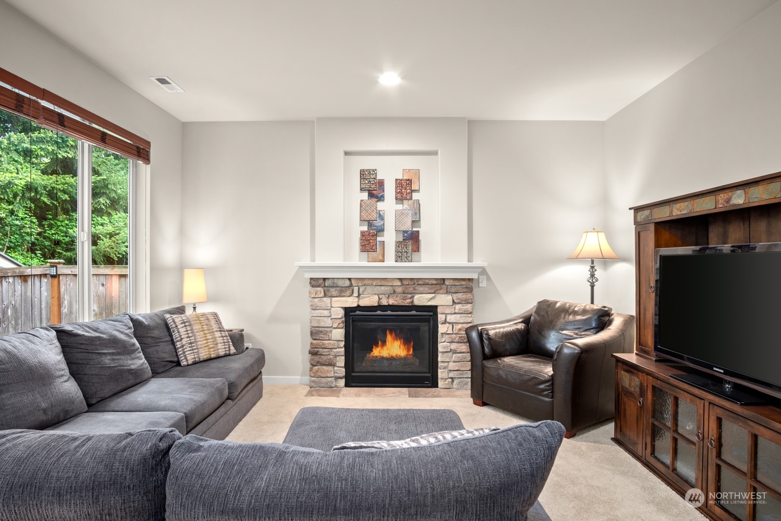 4806 Northeast 3rd Place Renton, WA 98059 - Photo 12 of 32 a living room with furniture a flat screen tv and a fireplace