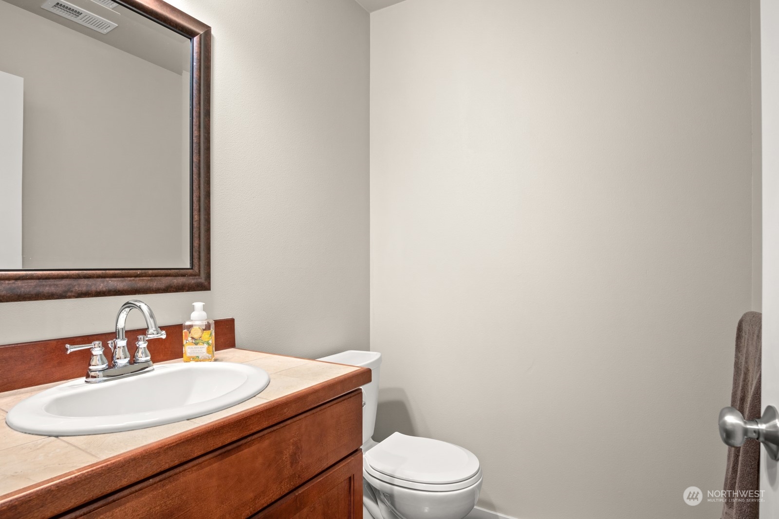 4806 Northeast 3rd Place Renton, WA 98059 - Photo 13 of 32 a bathroom with a sink a toilet and mirror