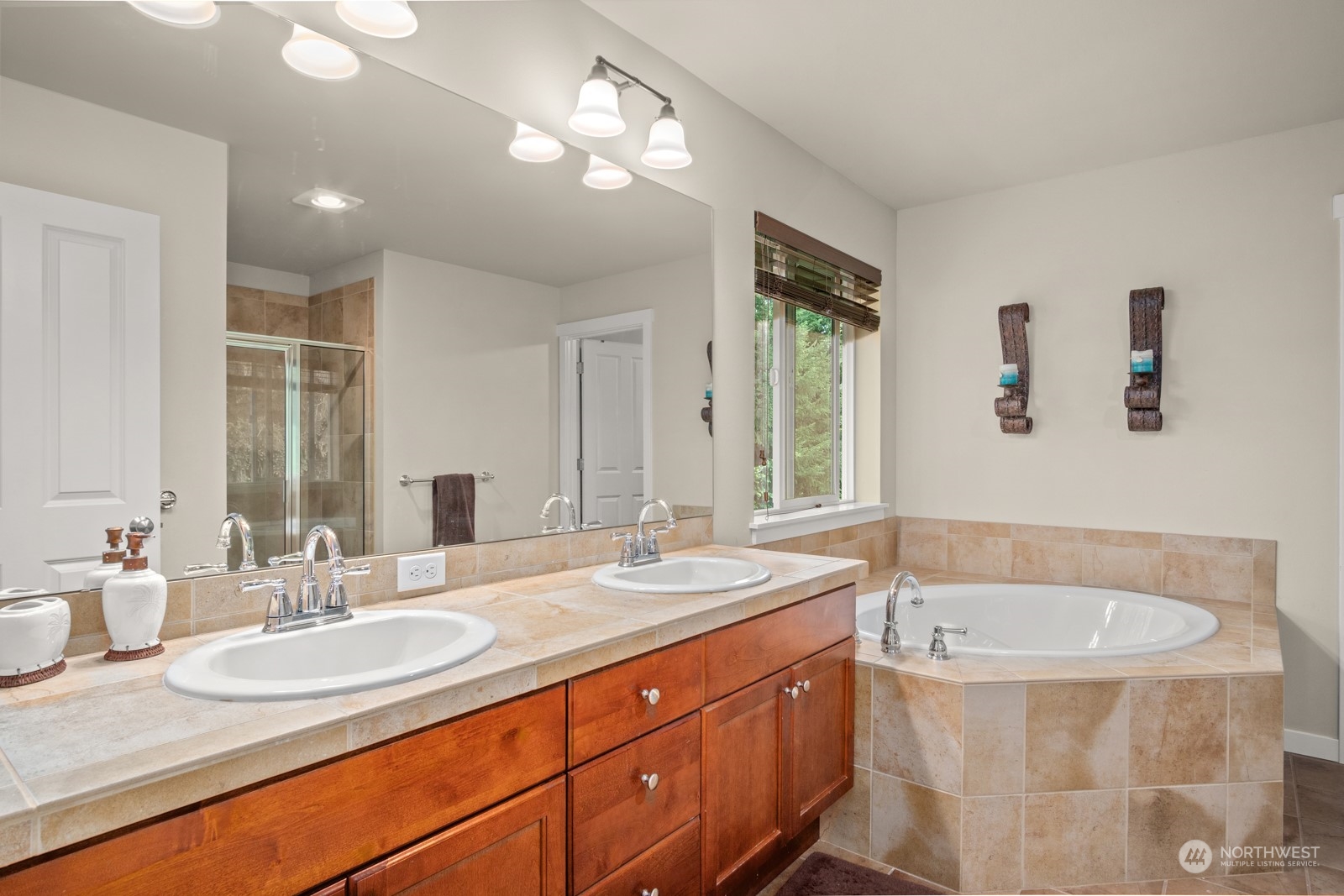 4806 Northeast 3rd Place Renton, WA 98059 - Photo 19 of 32 a bathroom with a granite countertop sink a bathtub a mirror and vanity