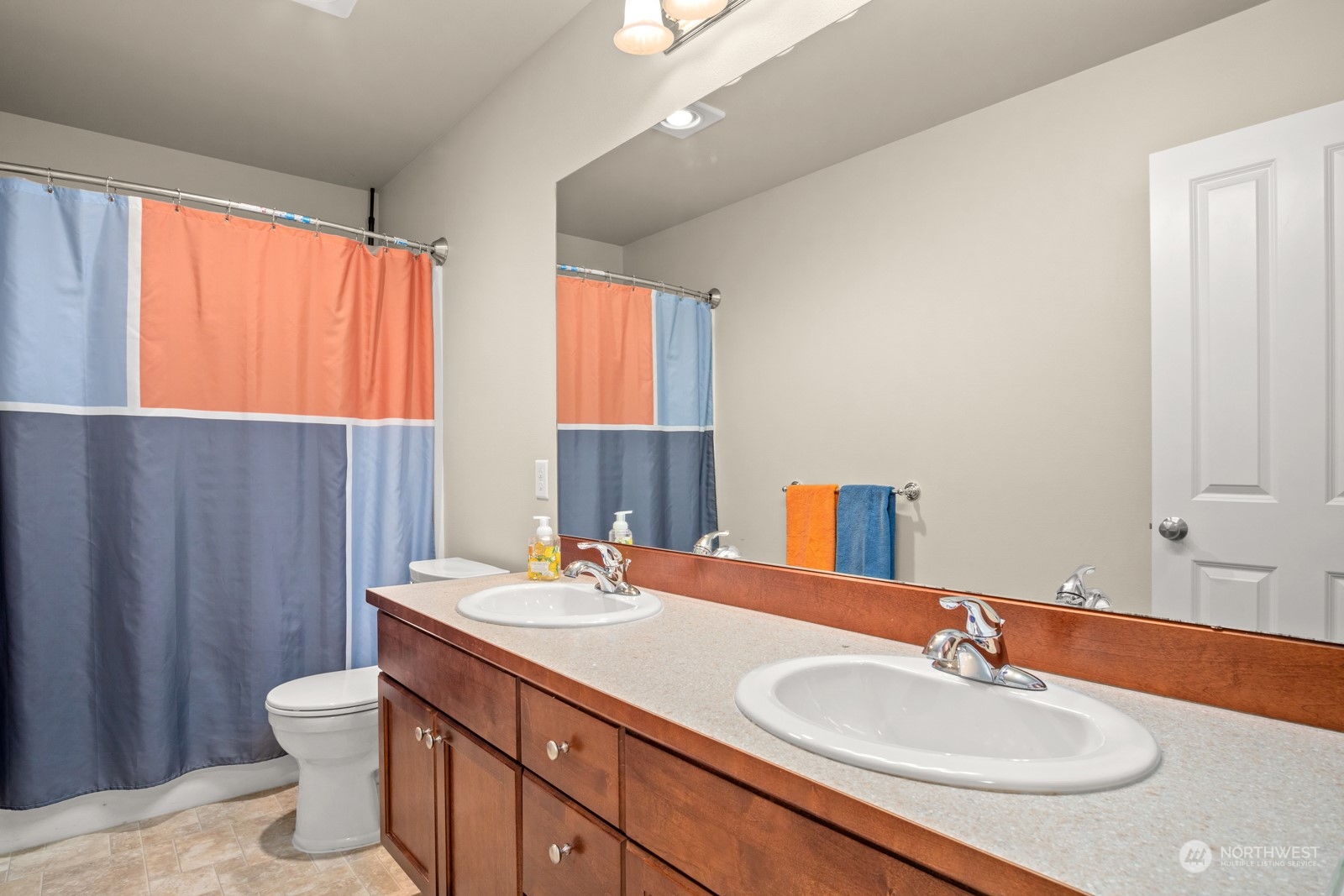 4806 Northeast 3rd Place Renton, WA 98059 - Photo 23 of 32 a bathroom with a double vanity sink toilet and a mirror