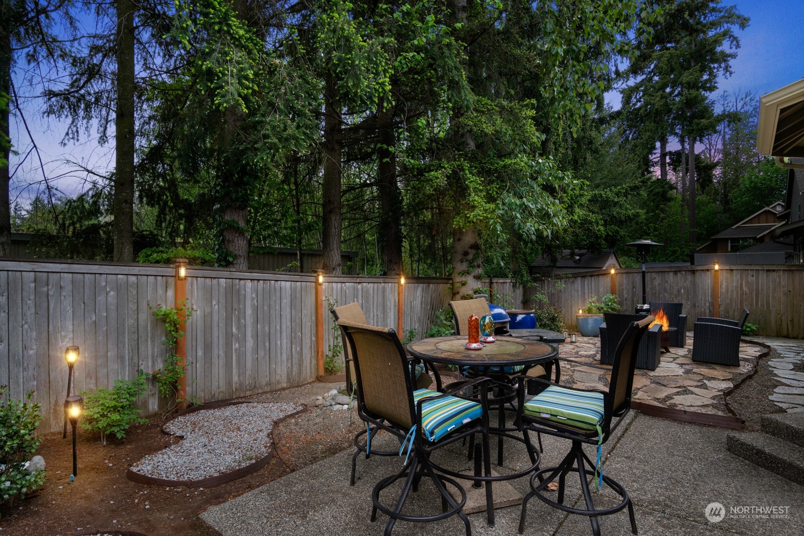 4806 Northeast 3rd Place Renton, WA 98059 - Photo 26 of 32 a backyard of a house with dining table and chairs with plants