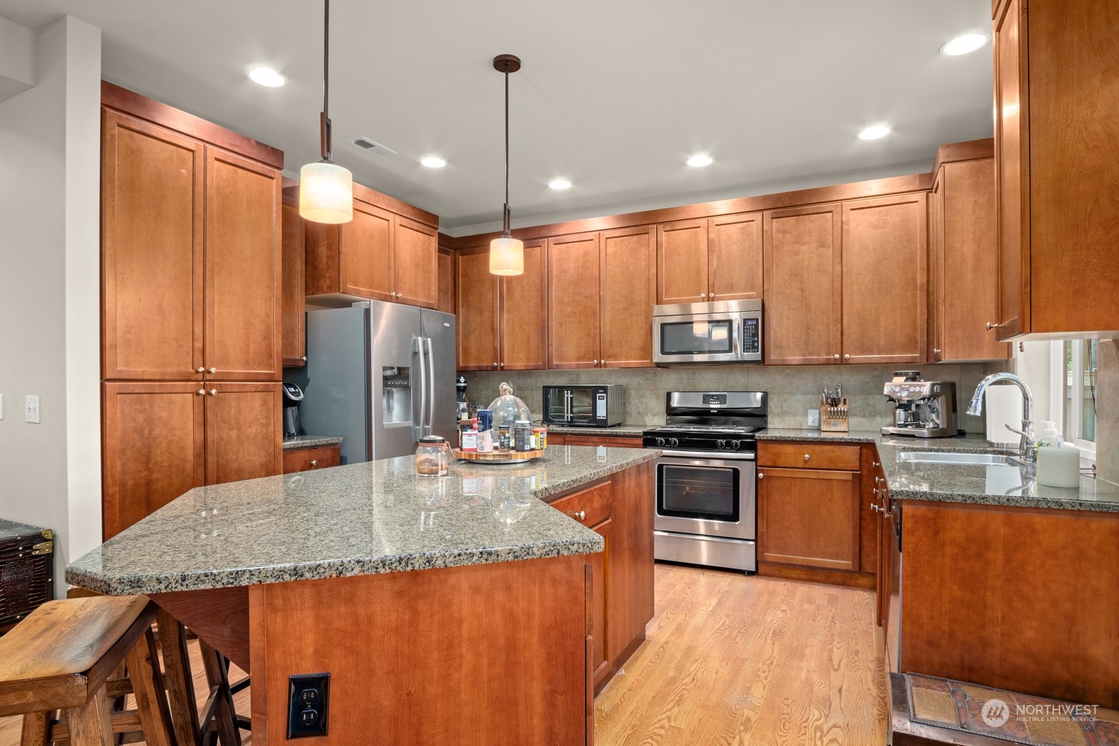 4806 Northeast 3rd Place Renton, WA 98059 - Photo 7 of 32 a kitchen with stainless steel appliances granite countertop a sink refrigerator and microwave
