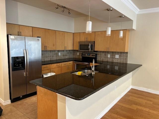 a kitchen with stainless steel appliances granite countertop a sink a refrigerator and a stove