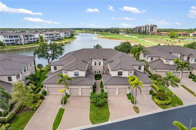 an aerial view of a house with a swimming pool yard and outdoor seating