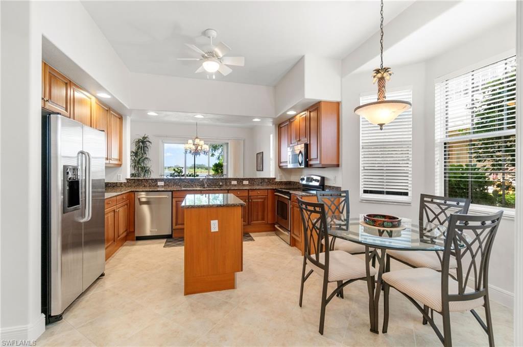 734 Regency Reserve Circle, Unit 2702 Naples, FL 34119 - Photo 15 of 48 a kitchen with stainless steel appliances granite countertop a stove a sink a refrigerator and a refrigerator