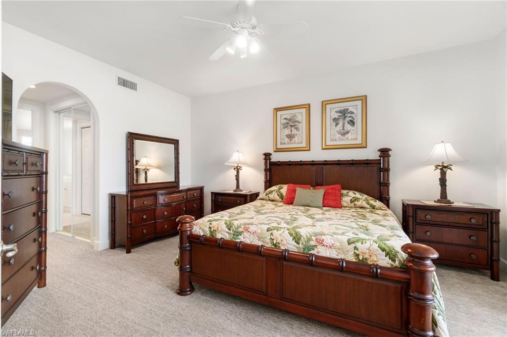 734 Regency Reserve Circle, Unit 2702 Naples, FL 34119 - Photo 24 of 48 a bedroom with a bed and a television