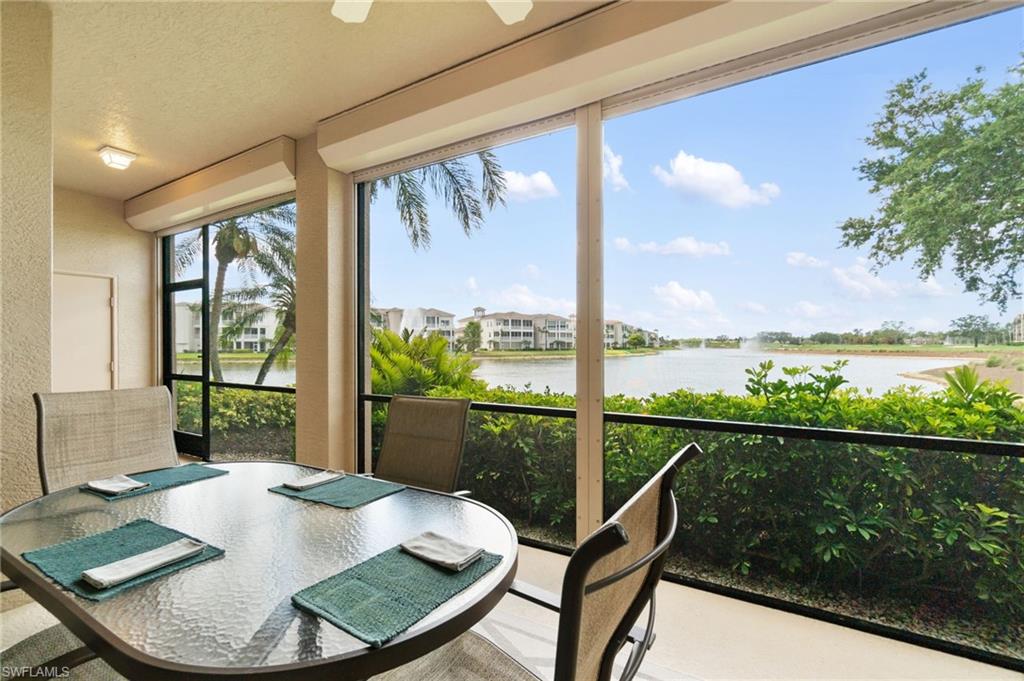 734 Regency Reserve Circle, Unit 2702 Naples, FL 34119 - Photo 29 of 48 a view of a dining room with furniture window and wooden floor