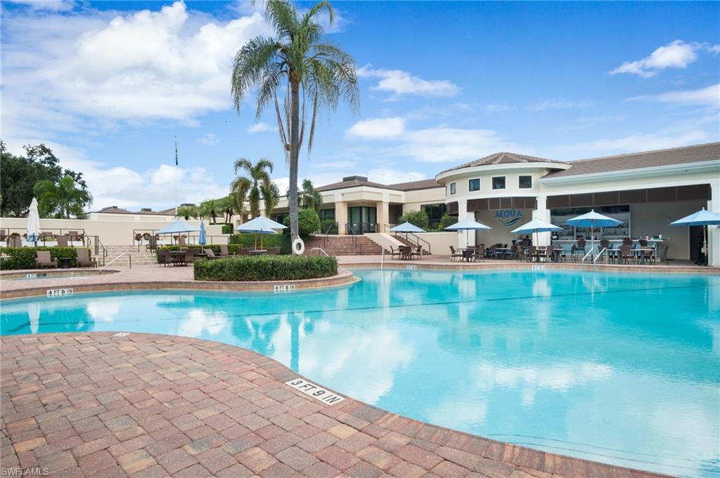 734 Regency Reserve Circle, Unit 2702 Naples, FL 34119 - Photo 38 of 48 a front view of a house with garden