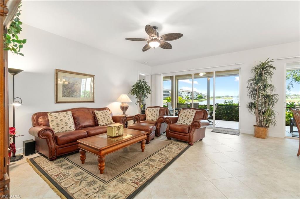 734 Regency Reserve Circle, Unit 2702 Naples, FL 34119 - Photo 7 of 48 a living room with furniture and a large window
