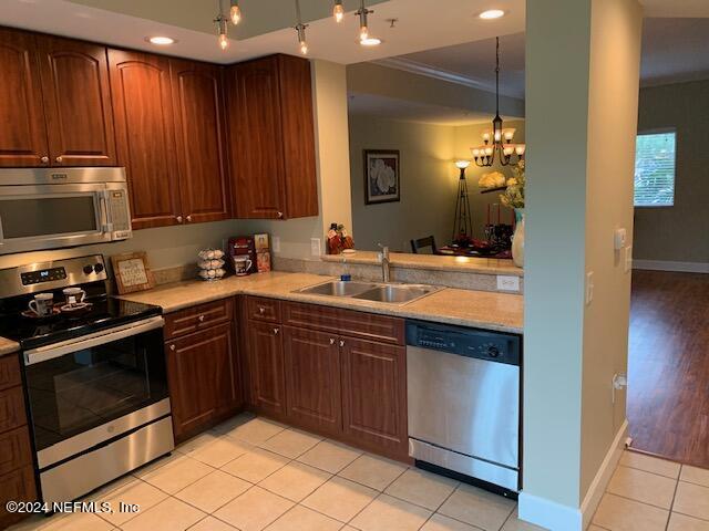 9745 Touchton Road, Unit 1805 Jacksonville, FL 32246 - Photo 38 of 77 a kitchen with a sink stove and microwave