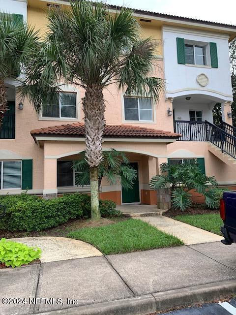 9745 Touchton Road, Unit 1805 Jacksonville, FL 32246 - Photo 4 of 77 a front view of a house with a yard and potted plants