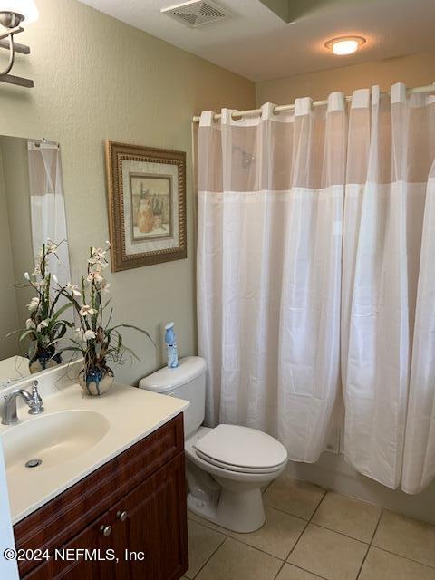 9745 Touchton Road, Unit 1805 Jacksonville, FL 32246 - Photo 69 of 77 a bathroom with a sink a toilet and shower curtain