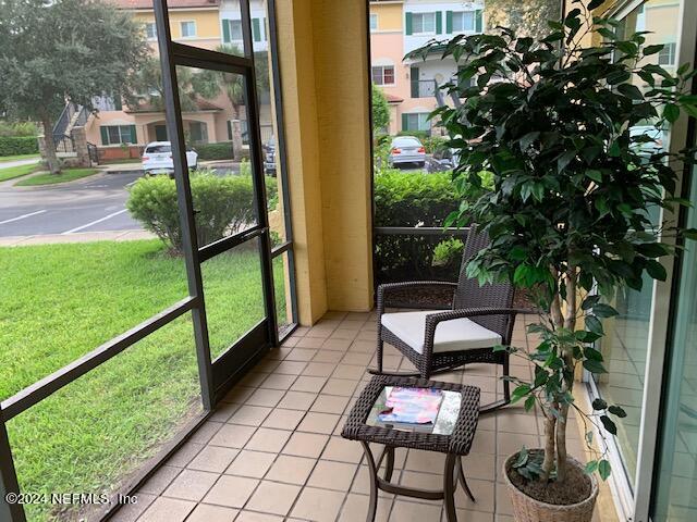 9745 Touchton Road, Unit 1805 Jacksonville, FL 32246 - Photo 75 of 77 a view of a chairs and table in patio next to a yard