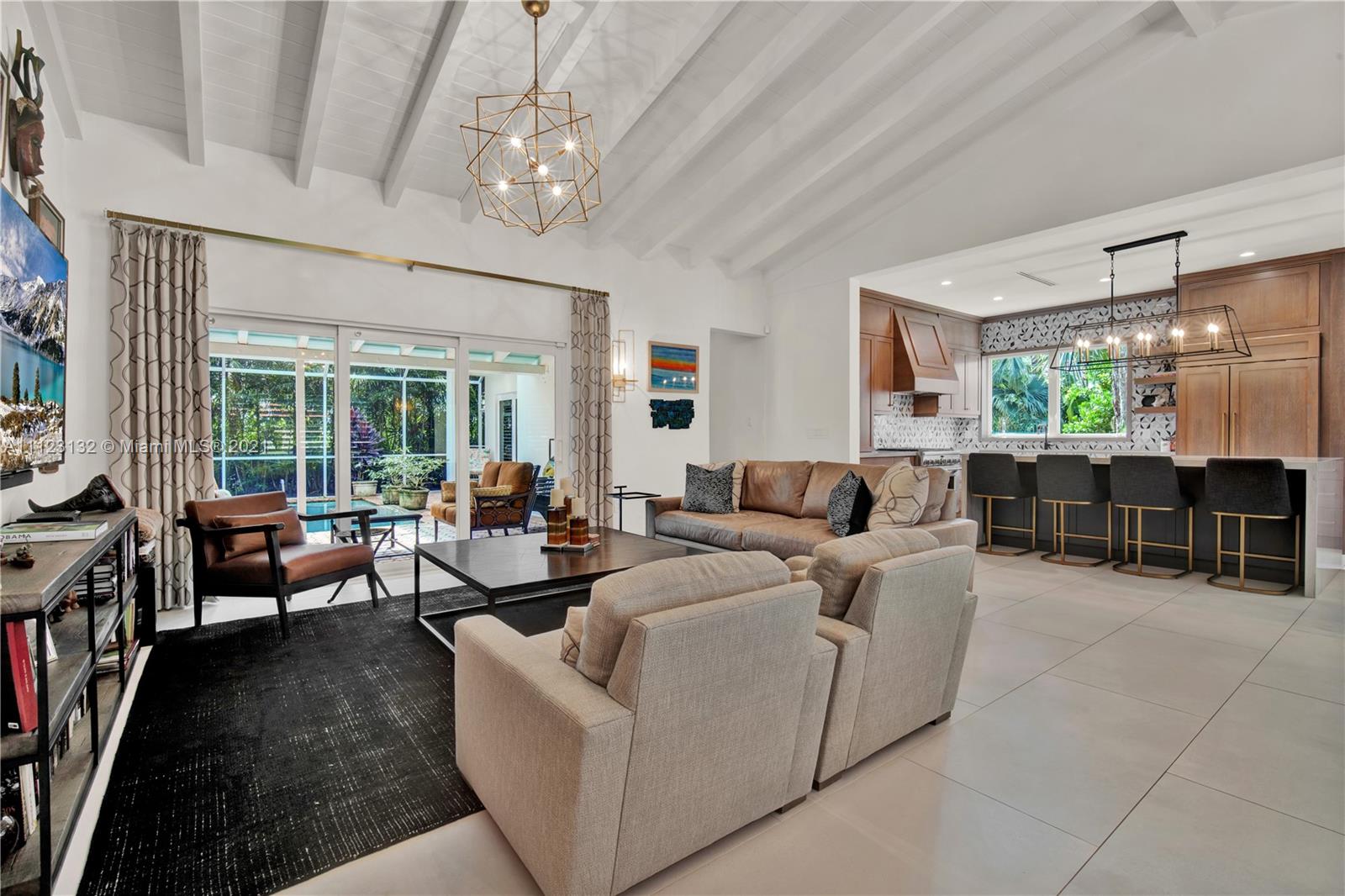 426 Hardee Road Coral Gables, FL 33146 - Photo 11 of 52 a living room with furniture and a chandelier