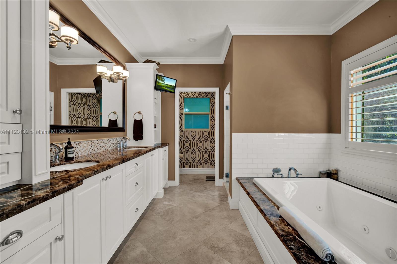 426 Hardee Road Coral Gables, FL 33146 - Photo 26 of 52 a bathroom with a granite countertop tub sink and mirror