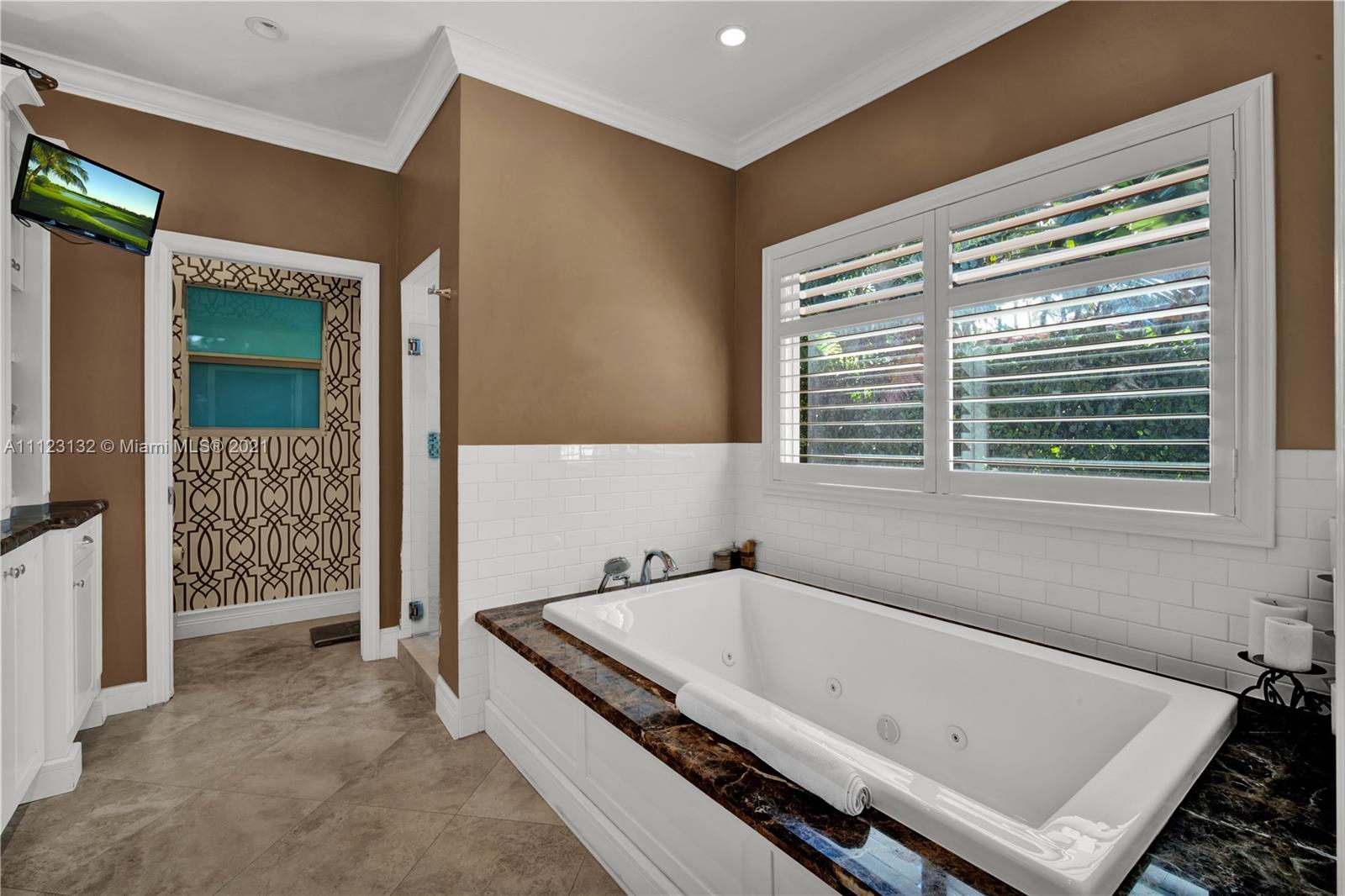 426 Hardee Road Coral Gables, FL 33146 - Photo 27 of 52 a bathroom with a tub a sink and a window