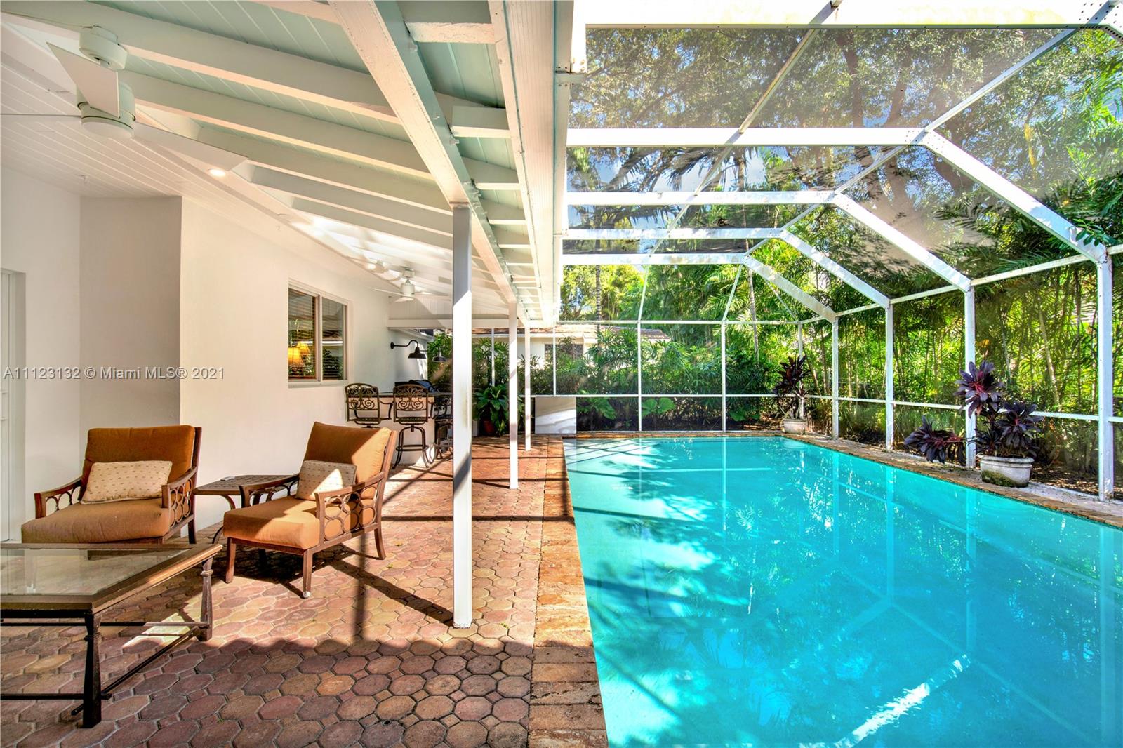 426 Hardee Road Coral Gables, FL 33146 - Photo 39 of 52 a view of a chair and tables in the back yard of the house