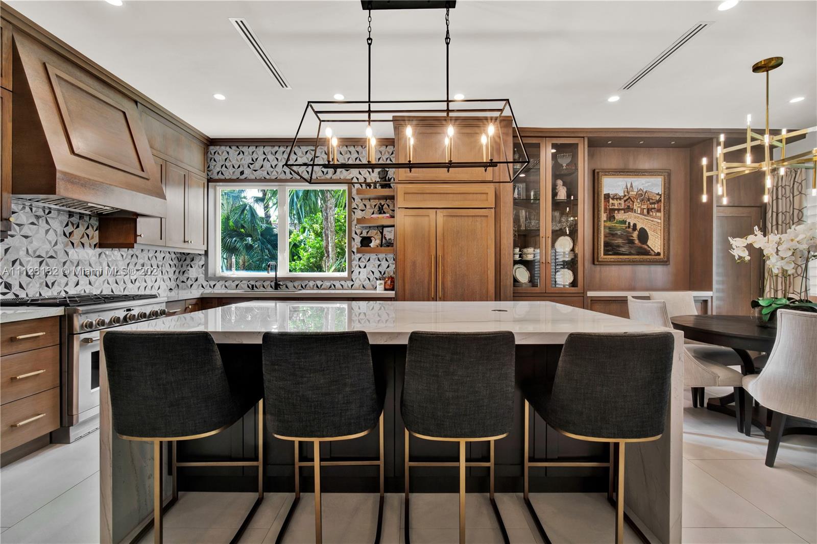 426 Hardee Road Coral Gables, FL 33146 - Photo 5 of 52 a kitchen with a dining table chairs stainless steel appliances and cabinets