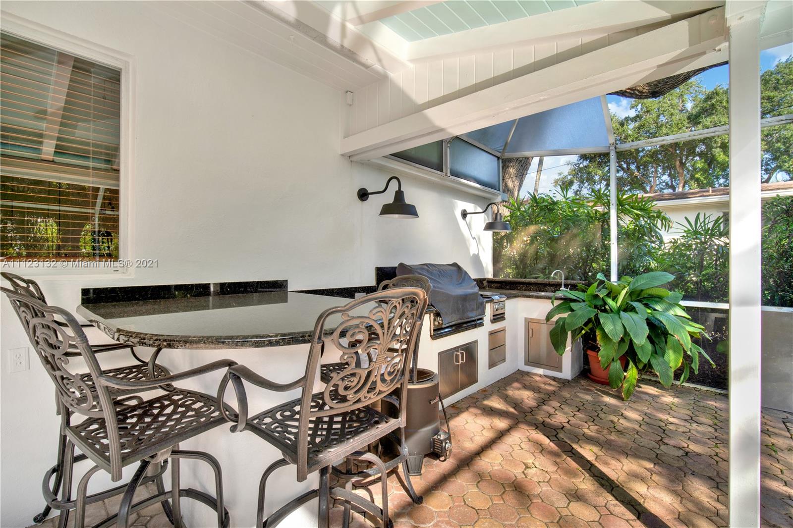 426 Hardee Road Coral Gables, FL 33146 - Photo 41 of 52 a view of a patio with table and chairs with wooden floor and plants