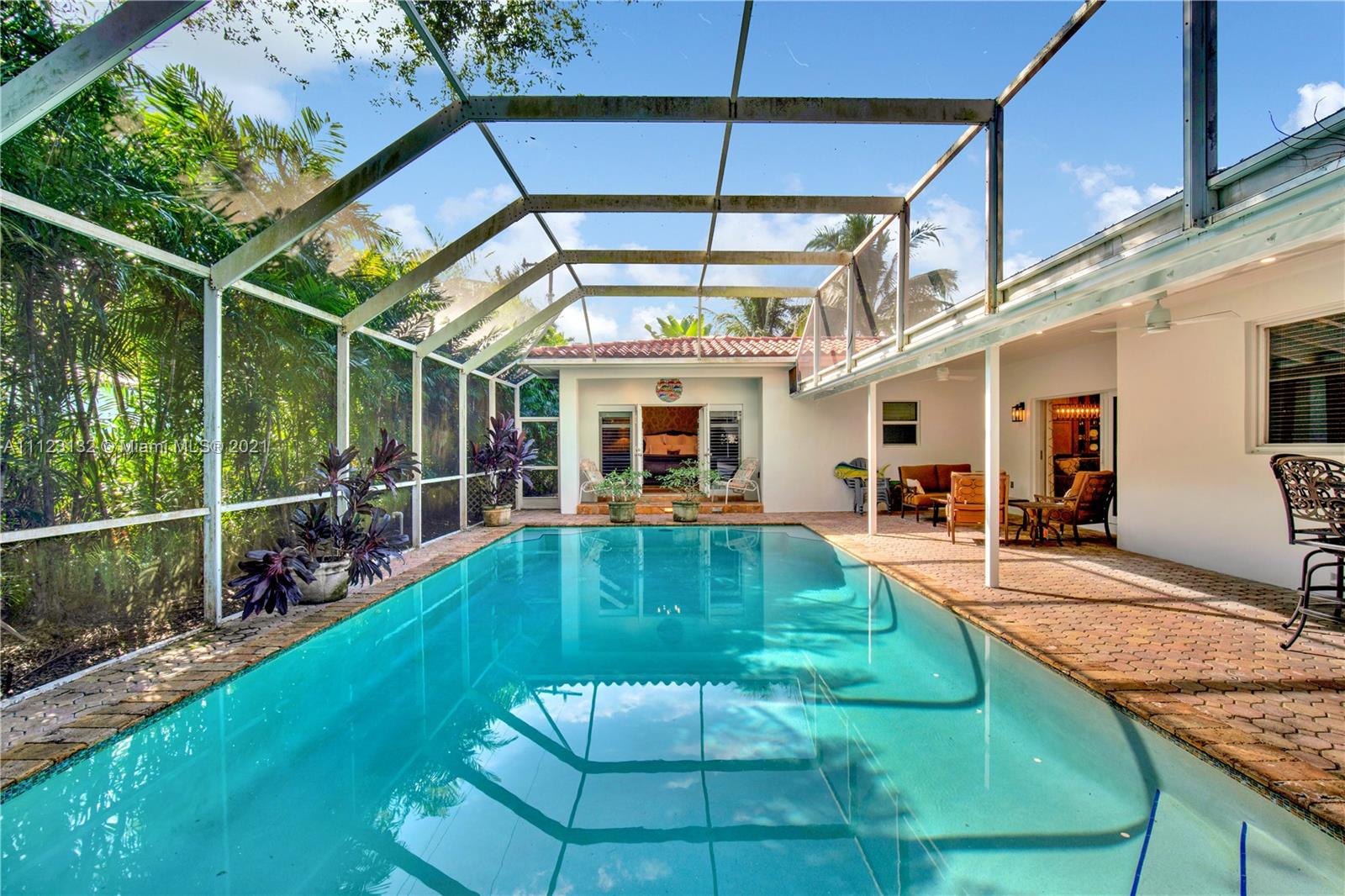 426 Hardee Road Coral Gables, FL 33146 - Photo 42 of 52 a view of a backyard with floor to ceiling window and potted plants
