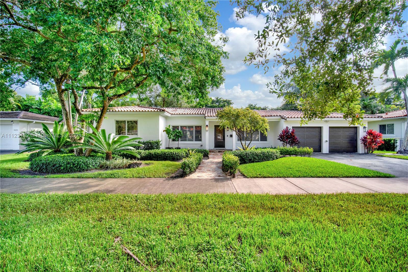 426 Hardee Road Coral Gables, FL 33146 - Photo 48 of 52 a front view of a house with a garden and yard