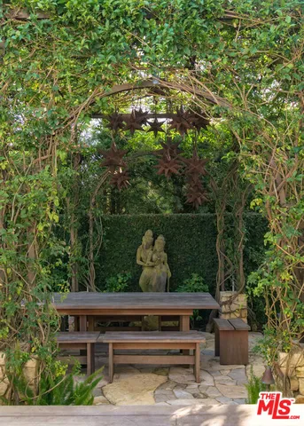 a view of a two chairs in a backyard
