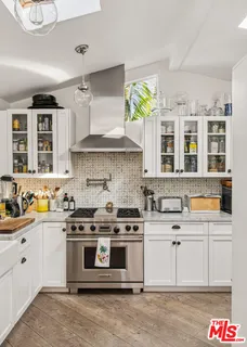 a kitchen with a stove sink and cabinets