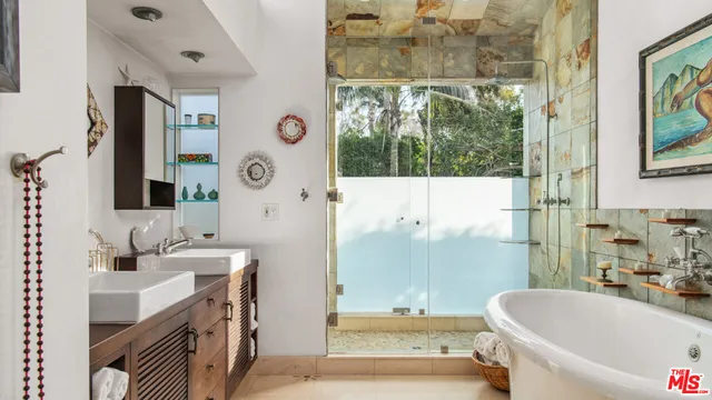 a bathroom with a tub sink and mirror