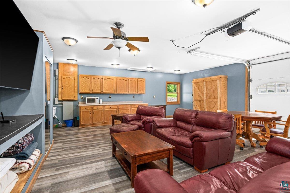 3799 South Lake Road Moose Lake, MN 55767 - Photo 25 of 35 Versatile multi-purpose space featuring wood-finish flooring, extensive cabinetry, a built-in countertop, and a ceiling fan
