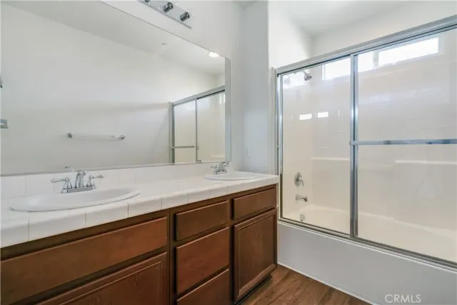 a bathroom with a granite countertop sink mirror and double