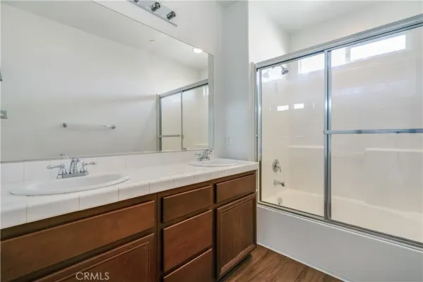 a bathroom with a granite countertop sink mirror and double
