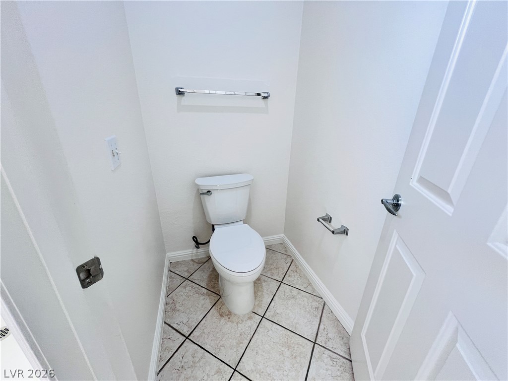 3047 Hickory Valley Road Henderson, NV 89052 - Photo 17 of 33 A well-lit powder room features neutral walls and practical tile flooring.