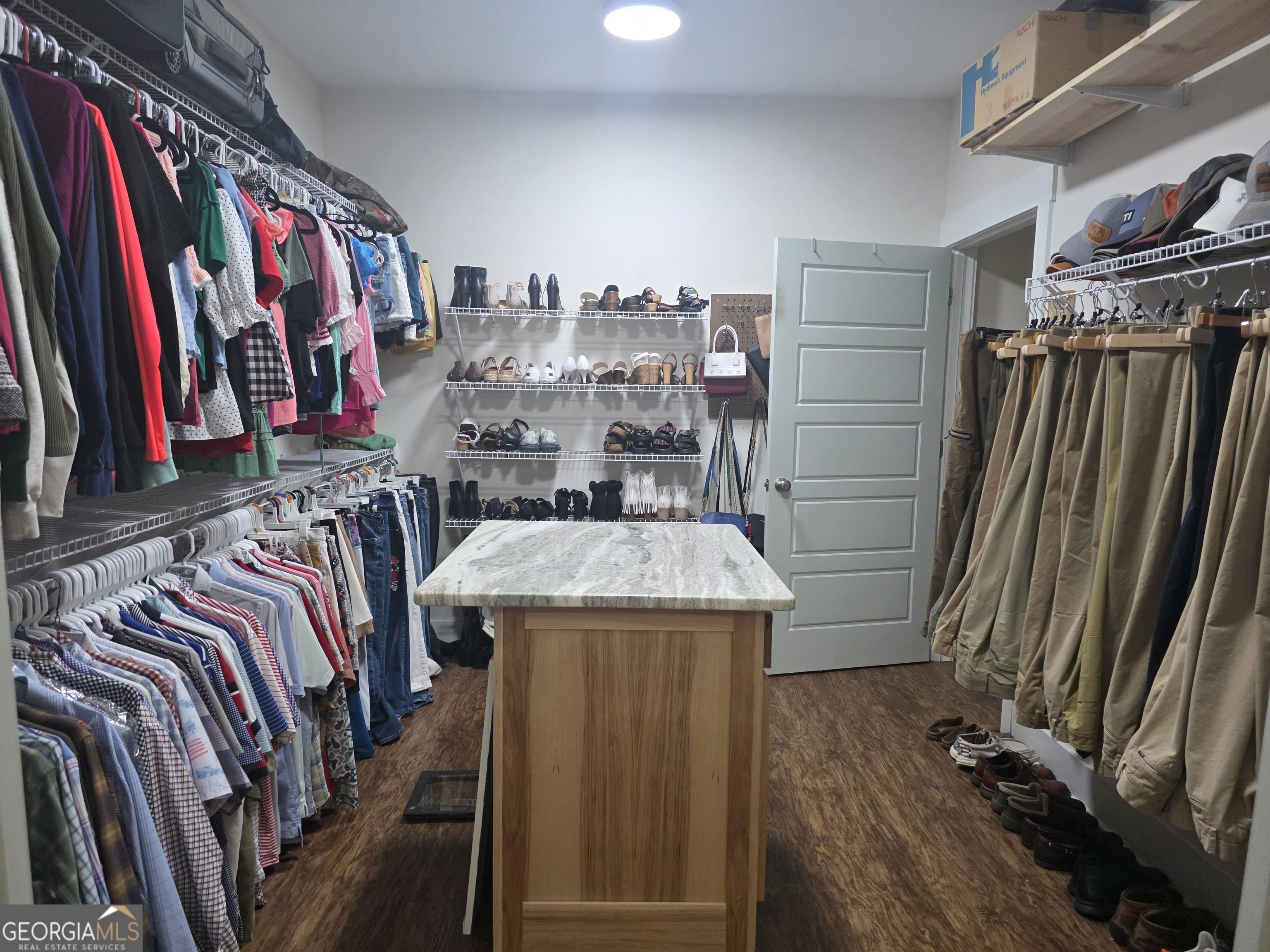 3060 Eatonton Road Madison, GA 30650 - Photo 32 of 65 a view of walk in closet with clothes and shoes