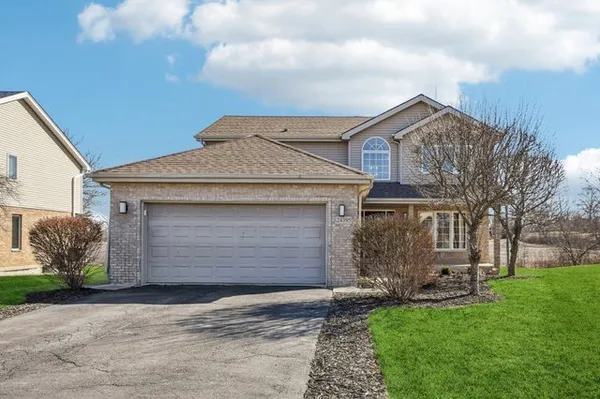 a view of a hallway with wooden floor and windows