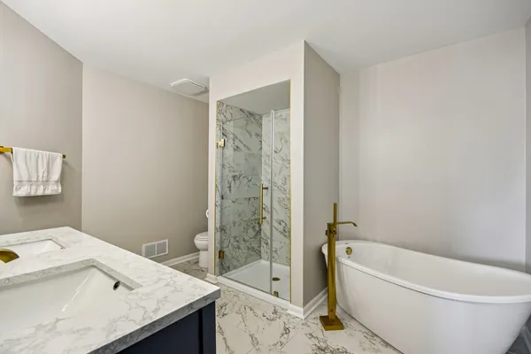 a bathroom with a sink a toilet and bathtub