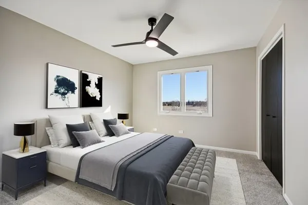 a bedroom with a large bed and a painting on the wall
