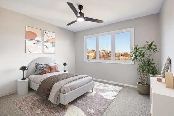 a bedroom with a large bed and a potted plant