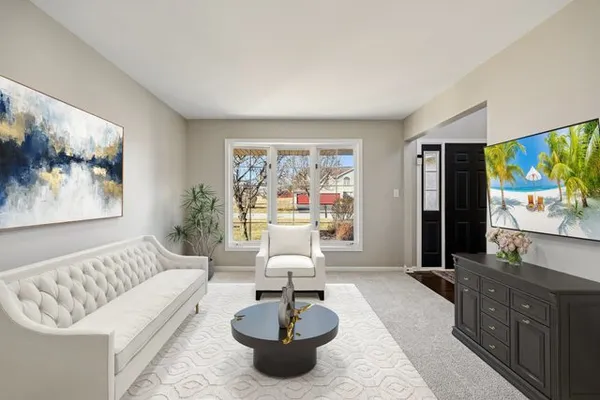 a living room with furniture a large window and a flat screen tv