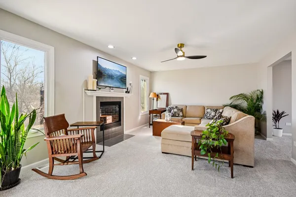a living room with furniture a fireplace and a flat screen tv