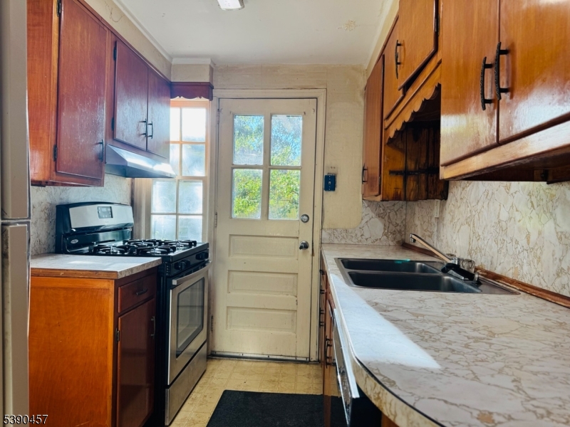 374 Raleigh Road Rahway, NJ 07065 - Photo 8 of 11 a kitchen with granite countertop a stove and a refrigerator