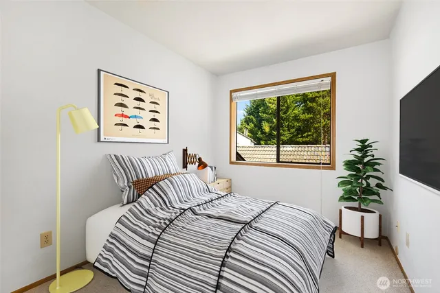 a bedroom with a bed and a window