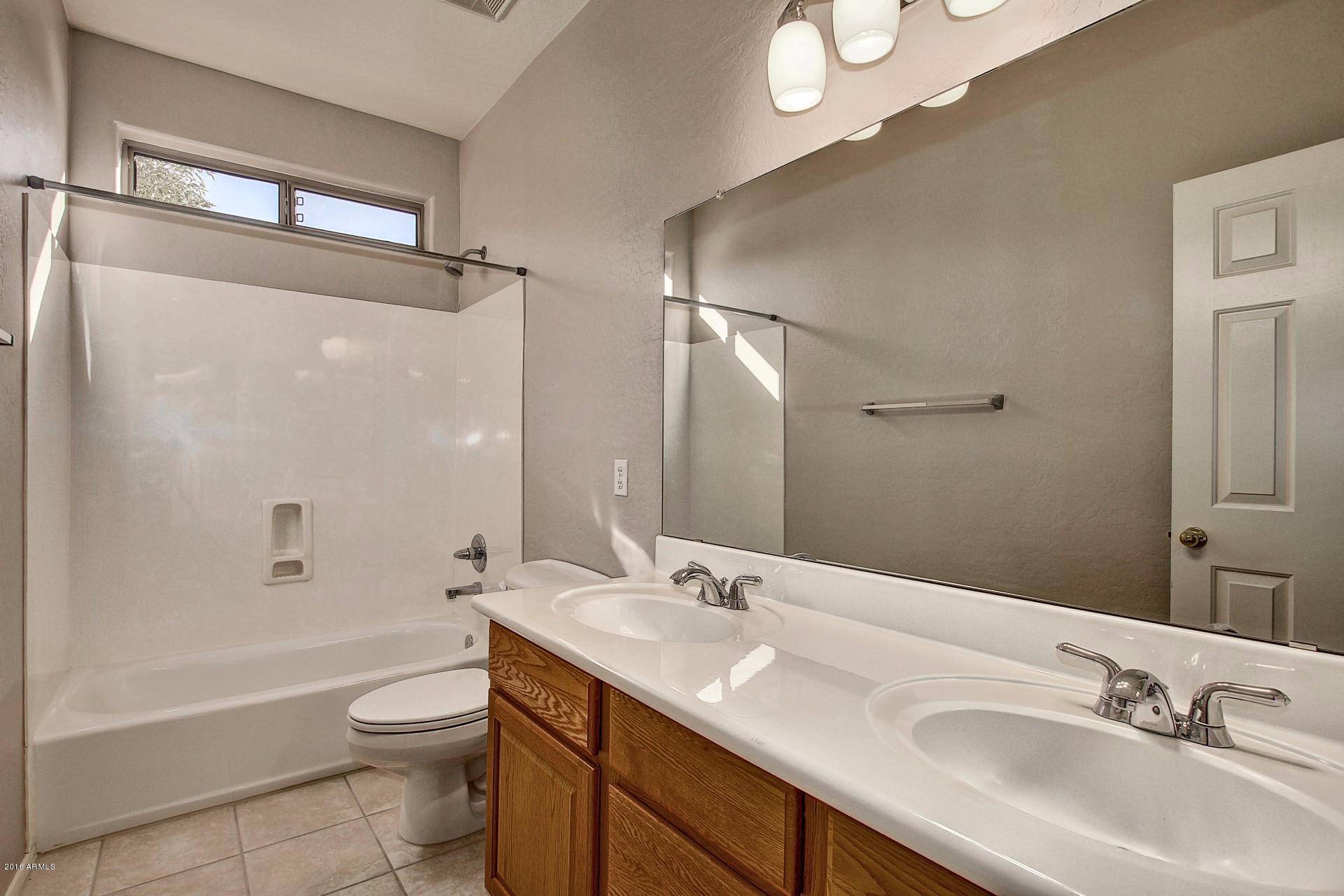 1360 East Harrison Street Gilbert, AZ 85295 - Photo 27 of 34 a bathroom with a sink a toilet and shower