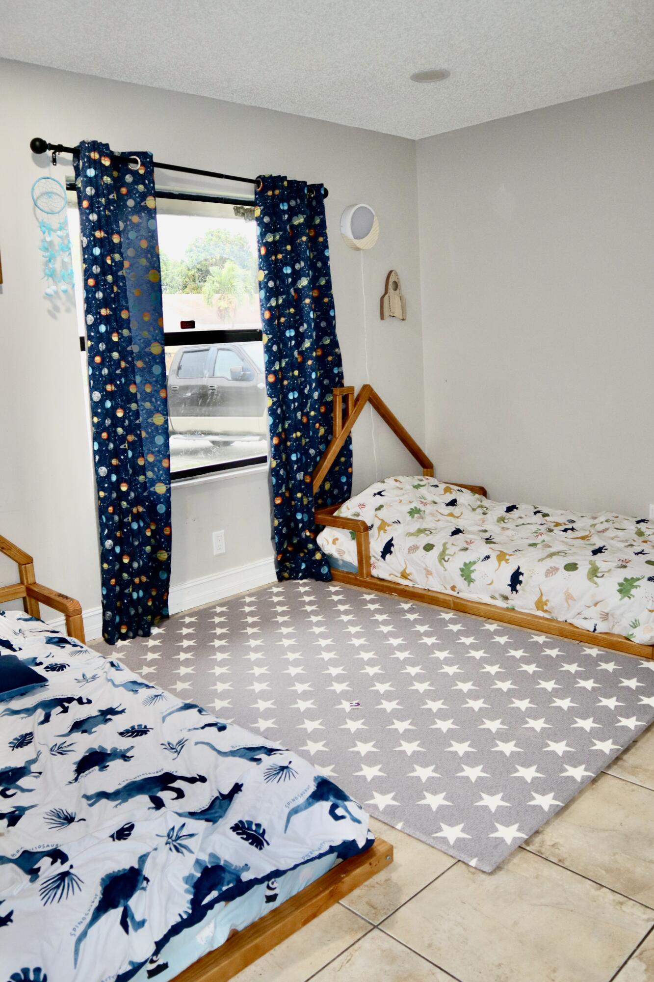 5905 Triphammer Road Lake Worth, FL 33463 - Photo 7 of 8 a bedroom with a bed and wooden floor