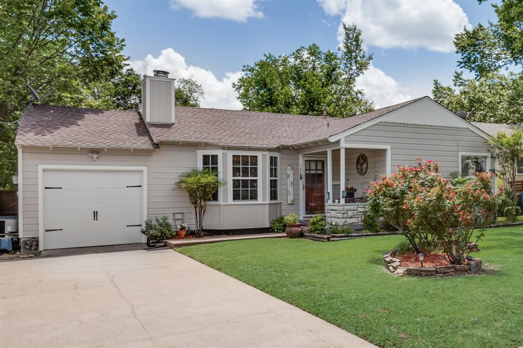 a front view of a house with a garden and plants