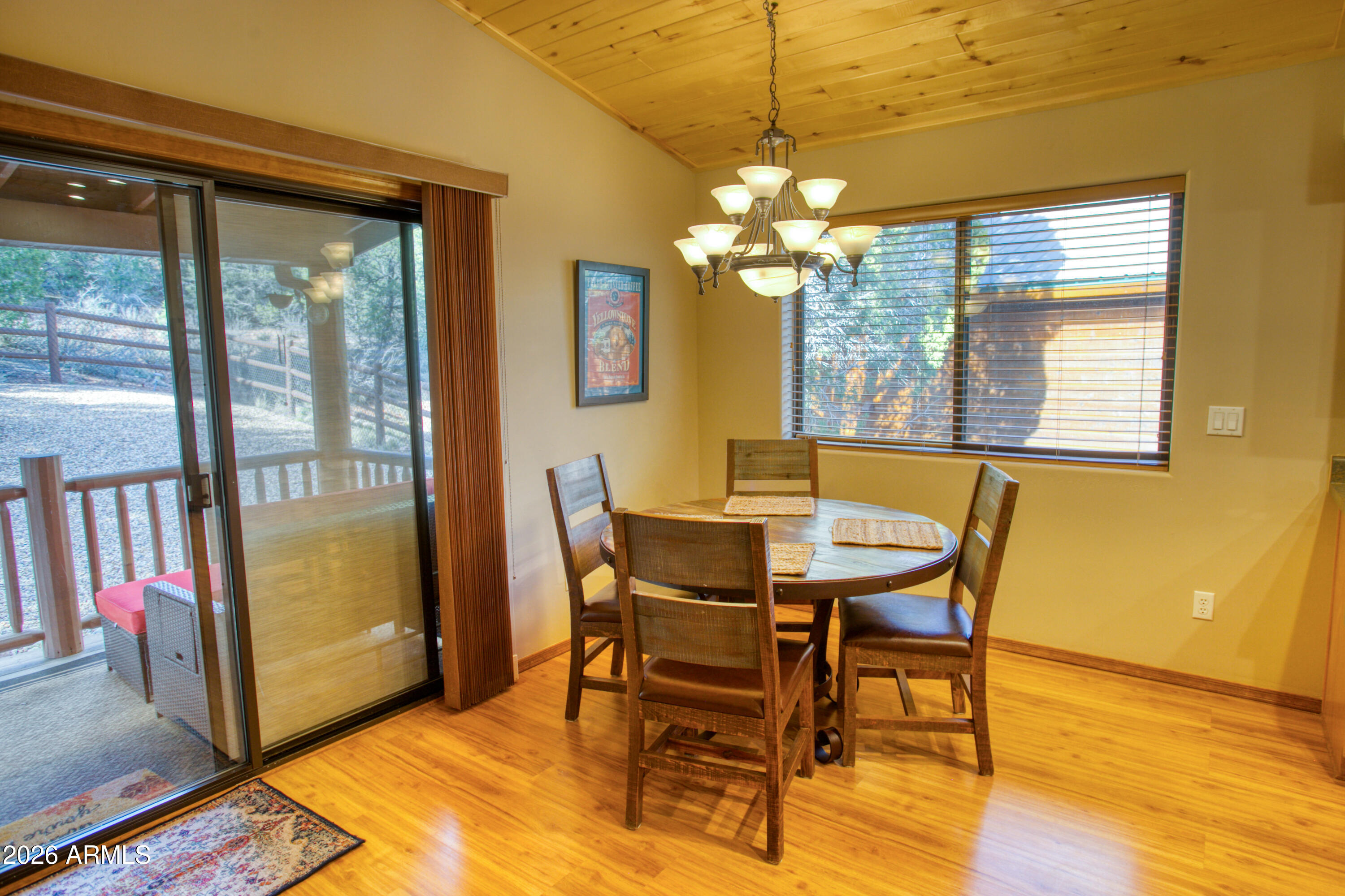 4840 West Cottage Loop Show Low, AZ 85901 - Photo 14 of 47 a view of a dining room with furniture a chandelier and wooden floor